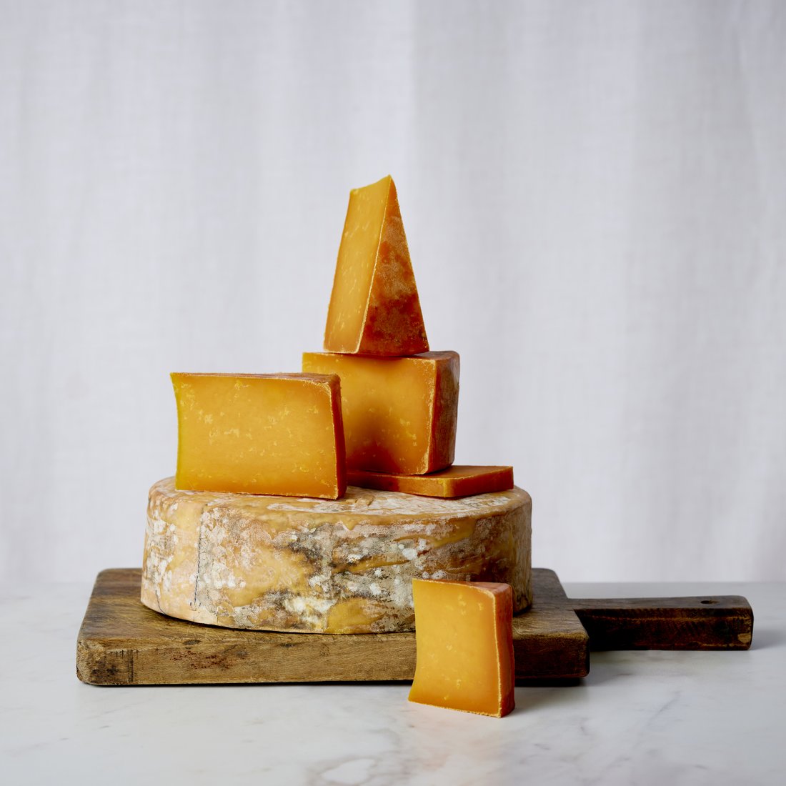 Long Clawson coloured cheese stack on a board